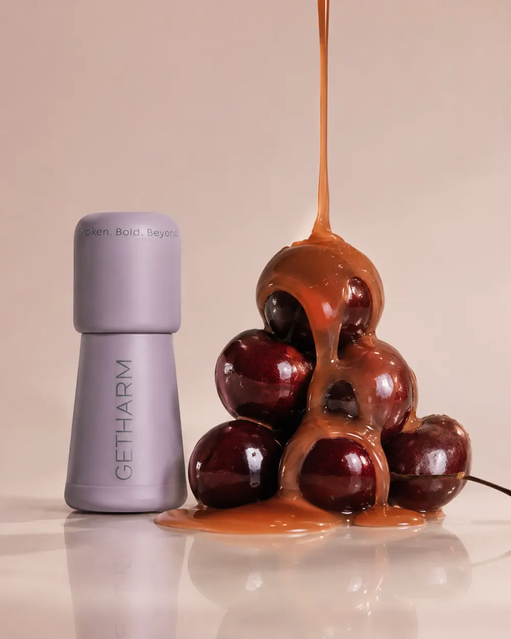 MatteLip beside caramel pouring over a stack of cherries