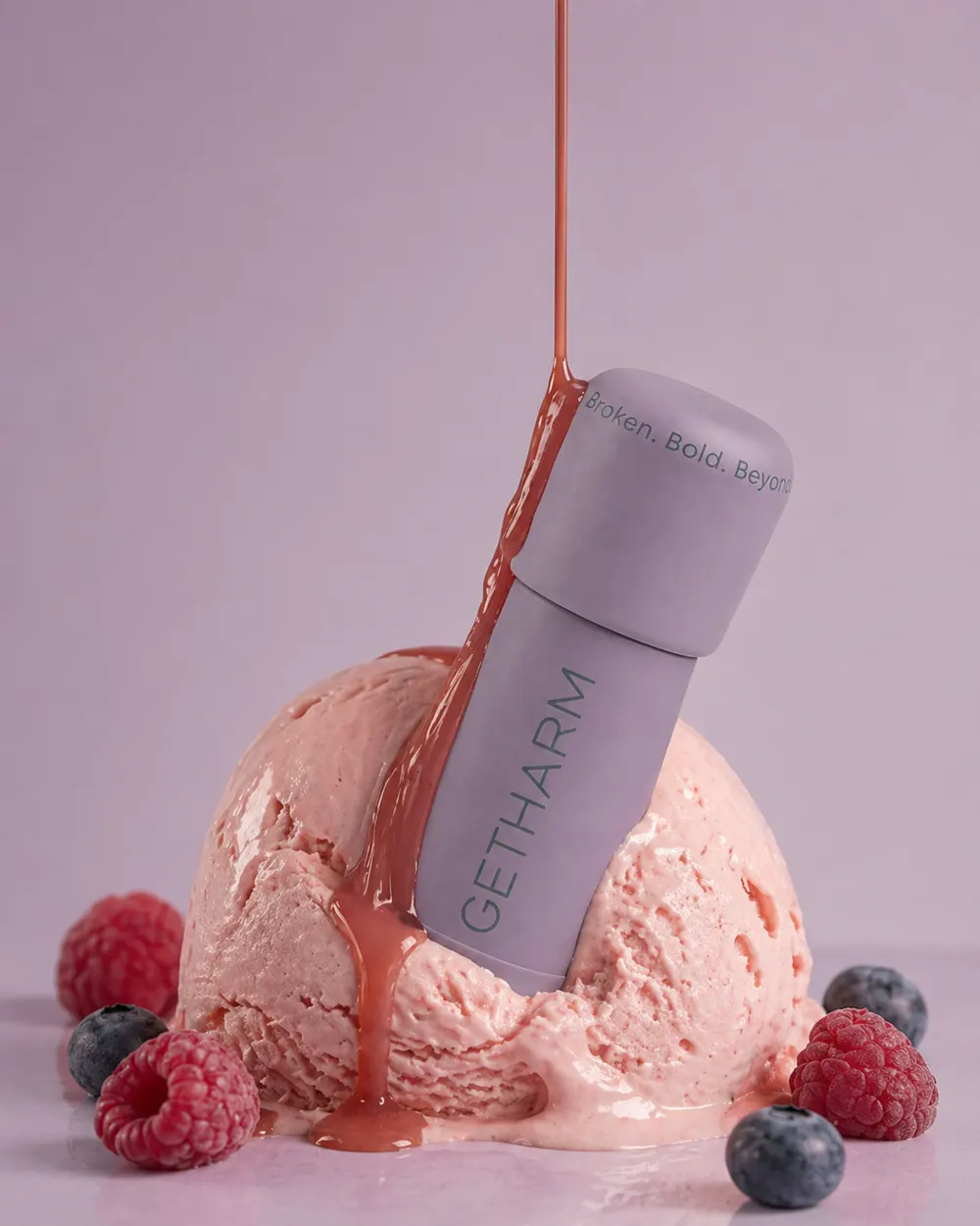 MatteLip bottle balanced on a scoop of pink ice cream with berries